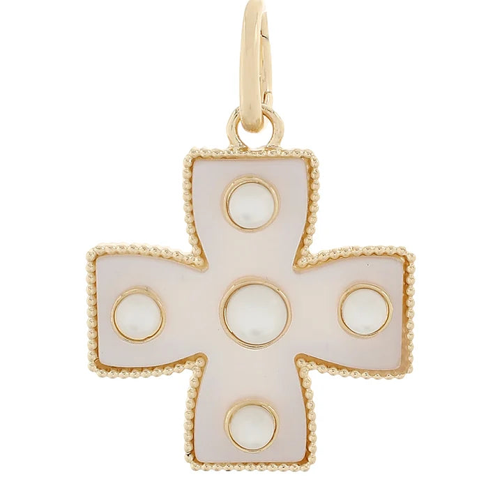 A gold cross pendant featuring a pearlescent white inlay with circular cutouts, set against a plain white background.