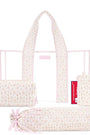 A light pink and white floral patterned diaper bag set shown on a white background, including the main tote bag, a smaller zip pouch, a rolled storage bag tied with a pink ribbon, and a folded view of the bag.