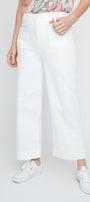 Person wearing white pants and white sneakers on a plain background