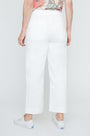 Person wearing white pants on a plain background