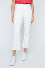 Person wearing white pants and white sneakers on a light gray background