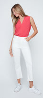 Woman wearing a pink sleeveless top and white pants on a white background