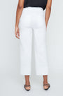 Person wearing white pants on a plain background