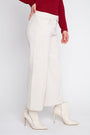A model wearing off-white wide-leg cropped pants, a dark red long-sleeve top, and off-white pointed-toe ankle boots with high stiletto heels, shown from the waist down on a light gray studio background.