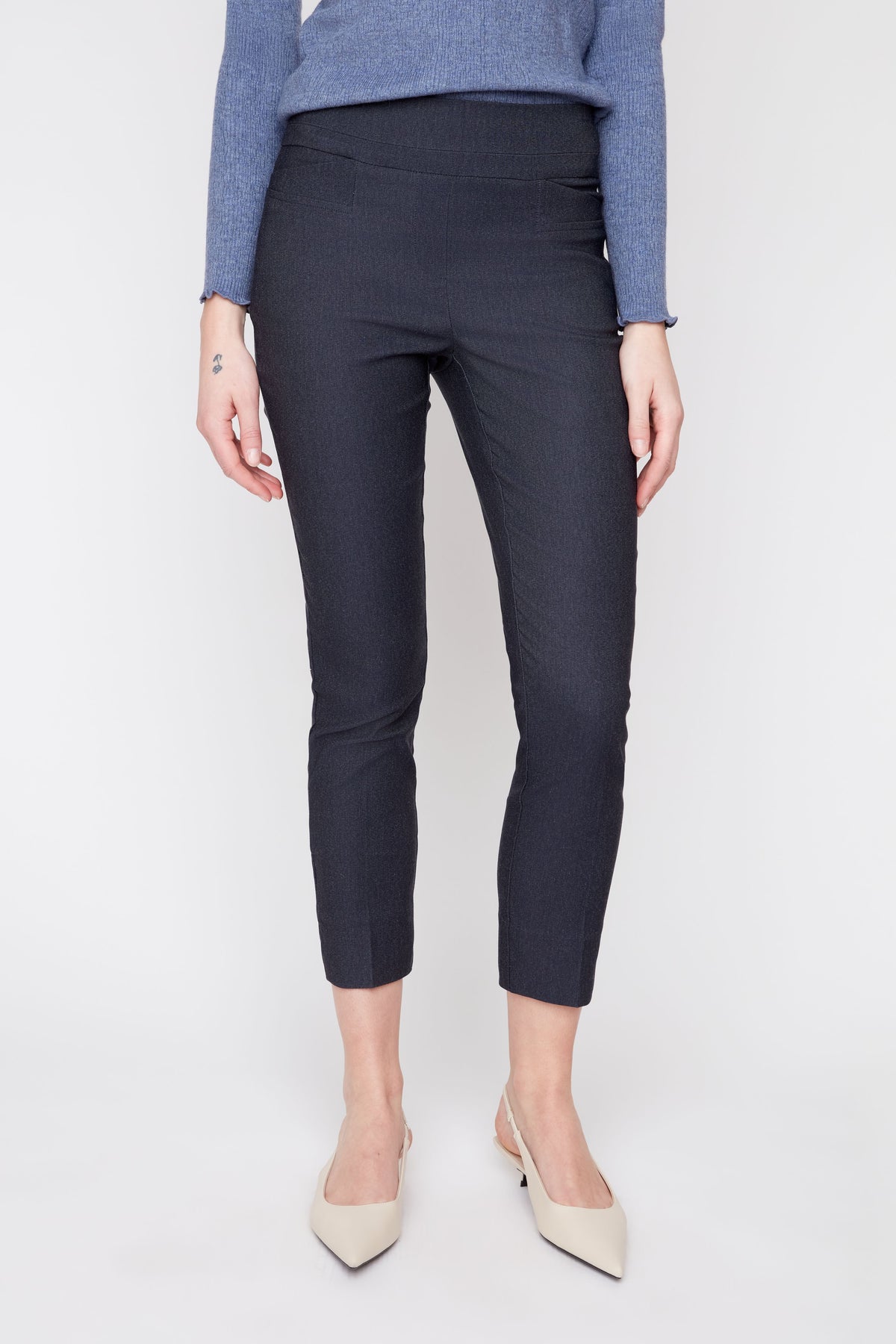 Person wearing navy blue pants on a white background