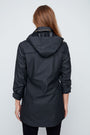Woman wearing a black raincoat on a white background