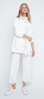 Woman wearing a white outfit on a plain background