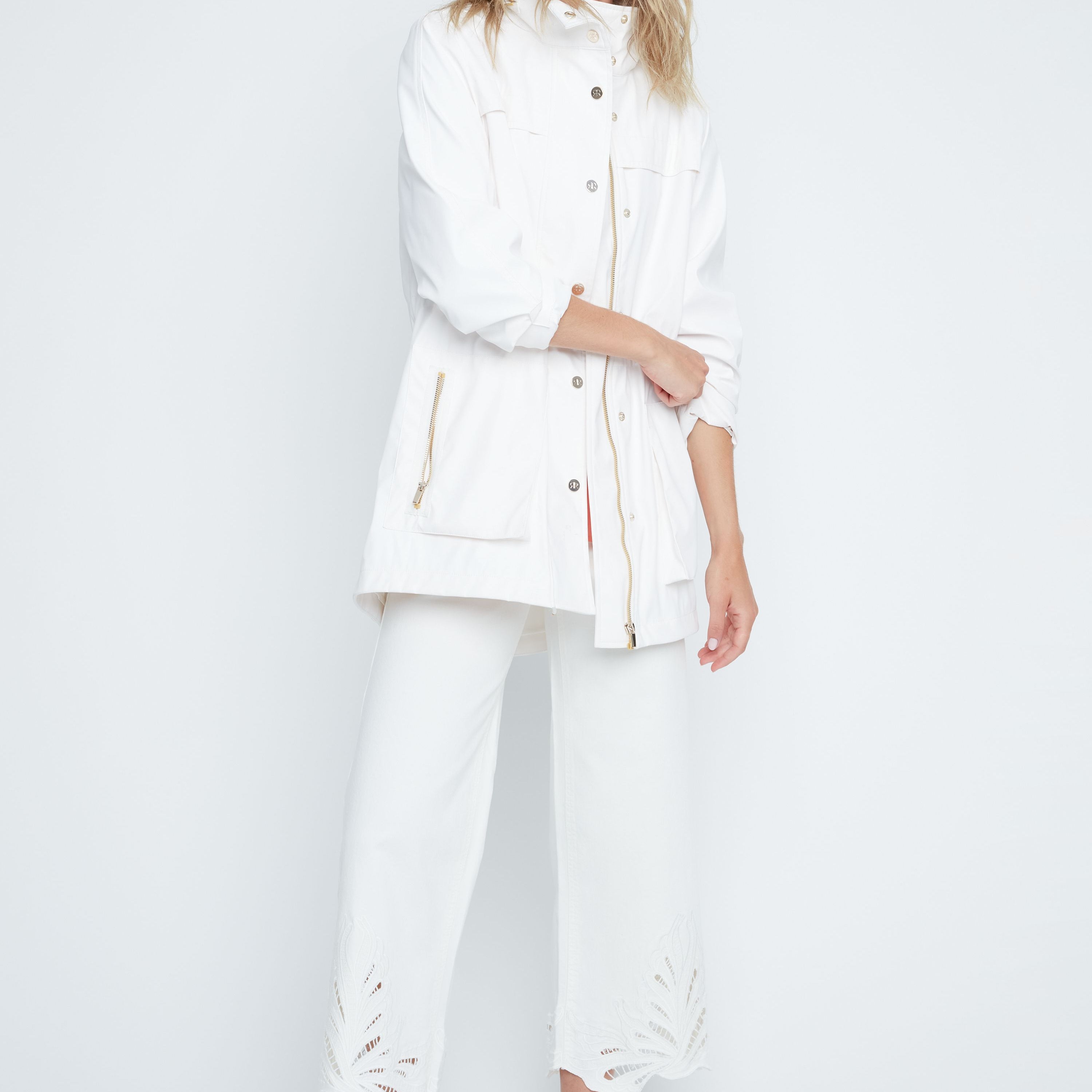 Woman wearing a white outfit on a plain background