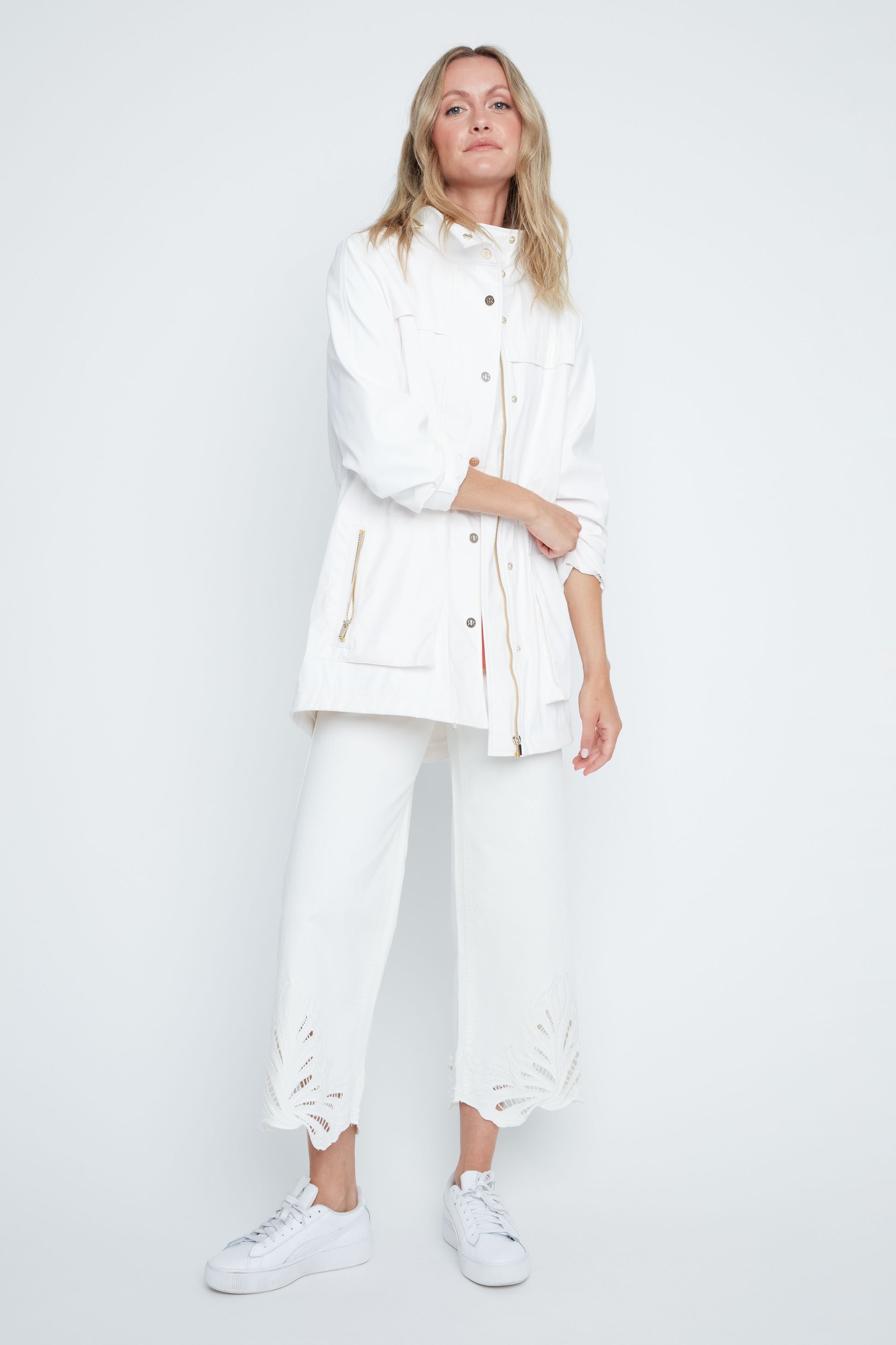 Woman wearing a white outfit on a plain background