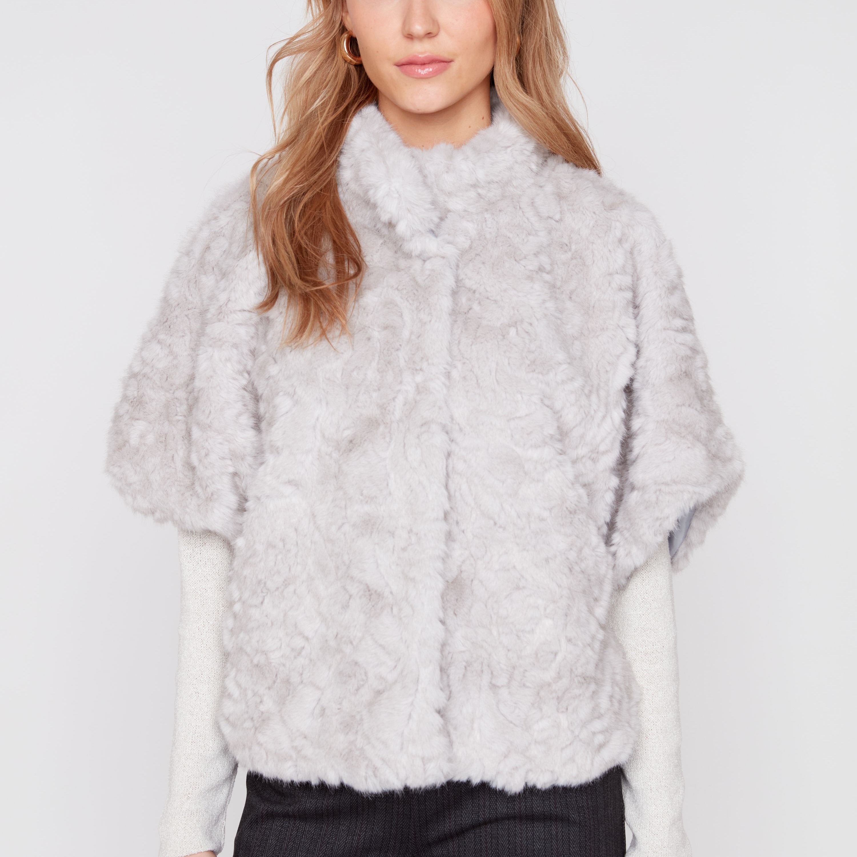 Light grey faux fur poncho with high neckline and textured shaggy finish