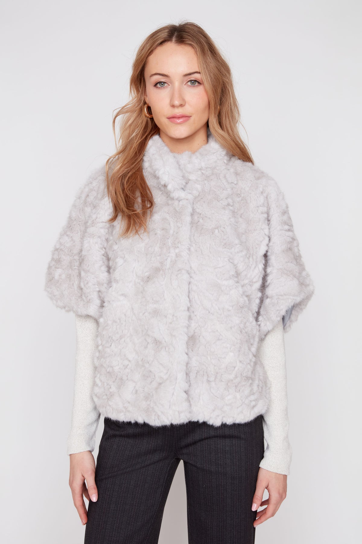 Light grey faux fur poncho with high neckline and textured shaggy finish