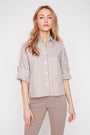 Woman wearing a striped shirt and beige pants on a white background