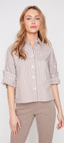 Woman wearing a striped shirt and beige pants on a white background