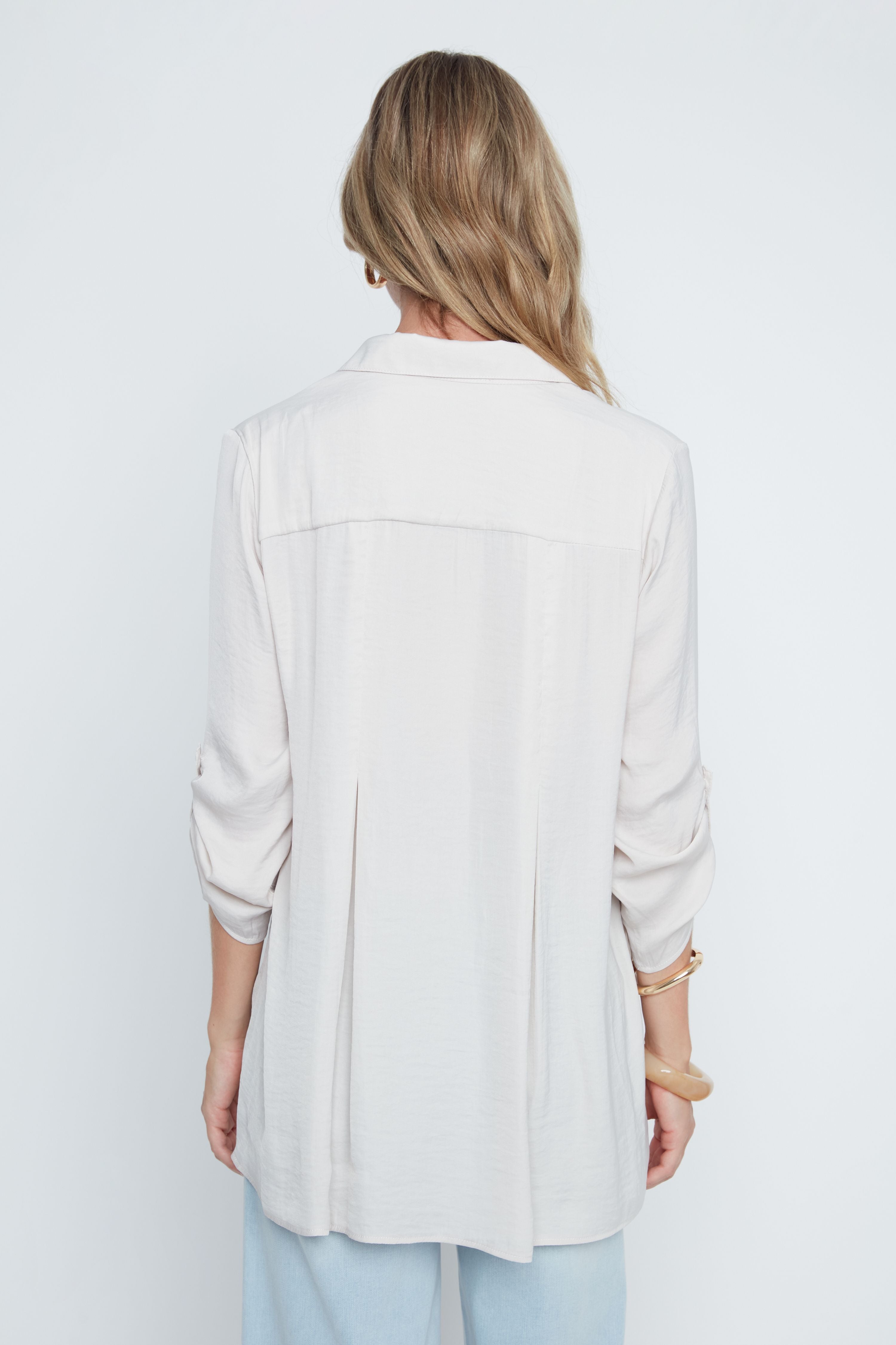 Woman wearing a light gray jacket on a white background