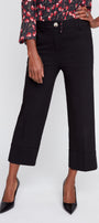 Person wearing black cropped pants with a floral blouse on a white background