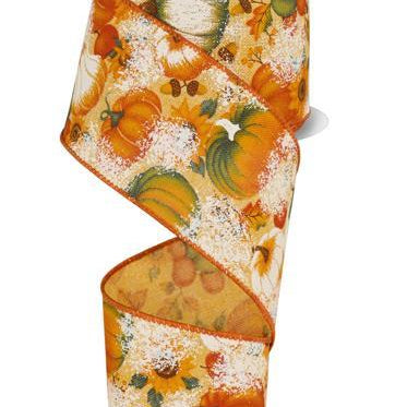 A spool of decorative ribbon with an autumn pumpkin and leaf pattern, featuring orange, green, and white motifs on a cream background with a glittery finish. The spool has a light blue label at the top.