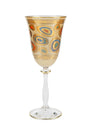 Decorative wine glass with gold and multicolor patterns on a white background