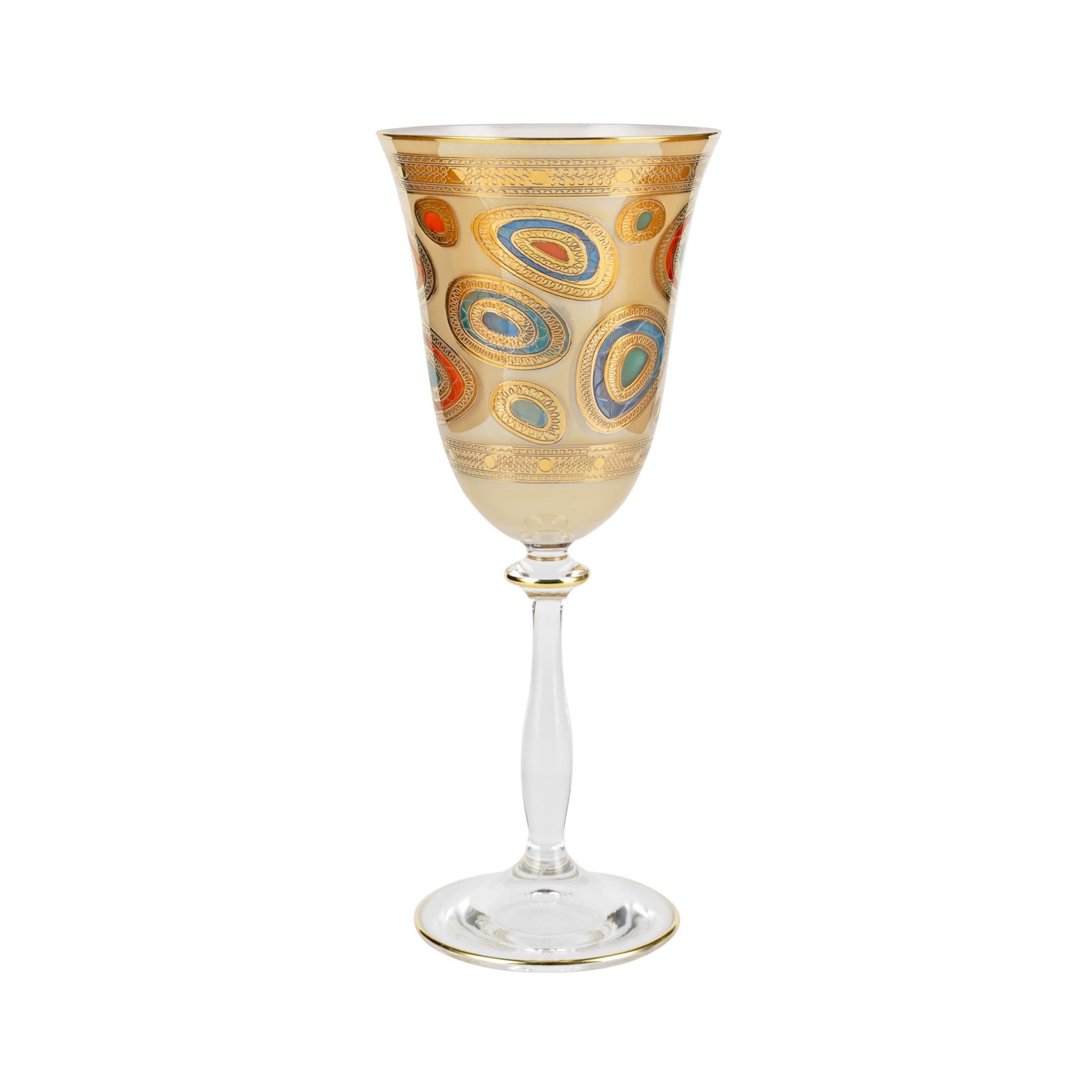 Decorative wine glass with gold and multicolor patterns on a white background