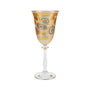 Decorative wine glass with gold and multicolor patterns on a white background