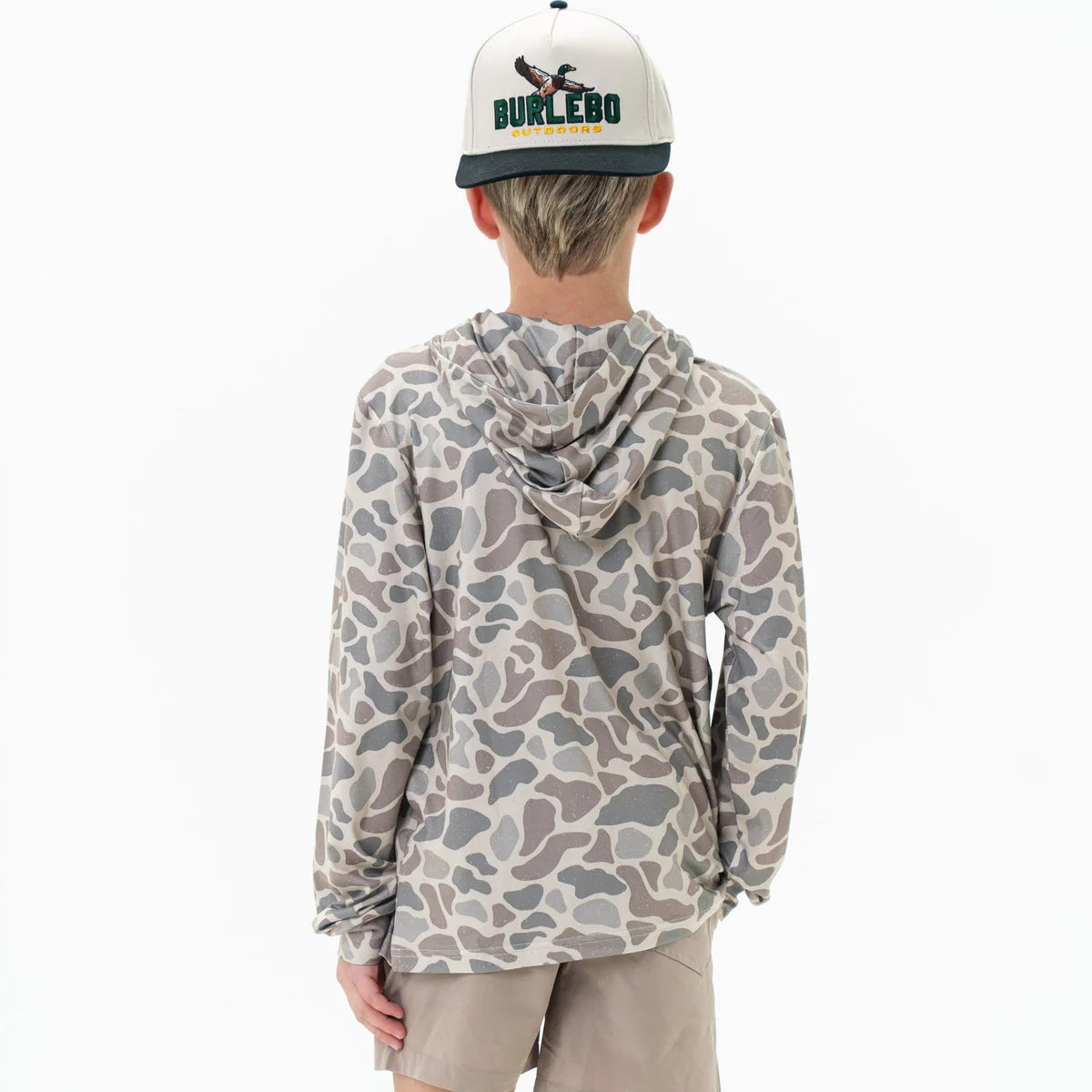 Person wearing a camouflage hoodie and a cap with 'Burlebo' branding on a white background