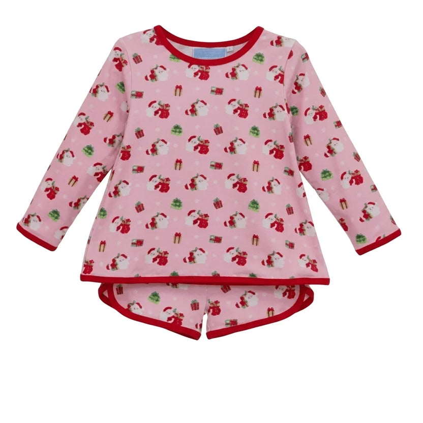 A children's long-sleeve pajama top in light pink with a repeating Santa Claus and gift print, finished with red trim on the collar, cuffs, and hem.