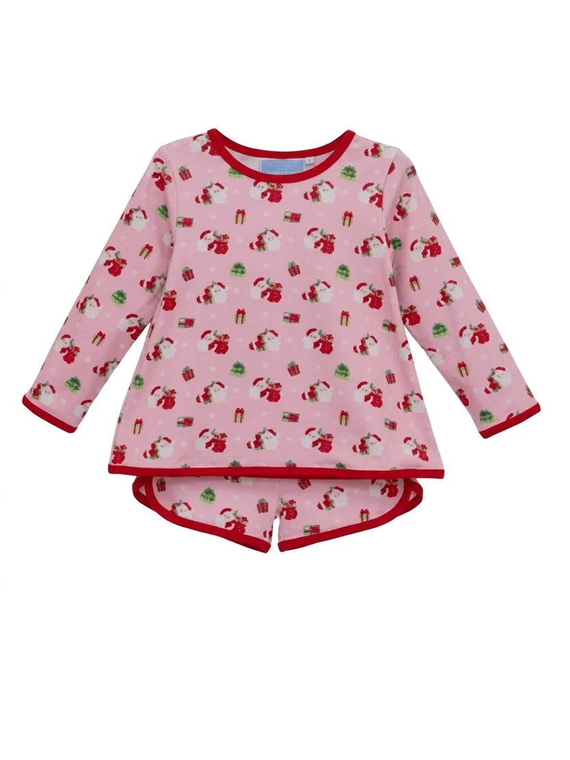 A children's long-sleeve pajama top in light pink with a repeating Santa Claus and gift print, finished with red trim on the collar, cuffs, and hem.