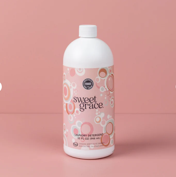 Bottle of Sweet Grace laundry detergent on a pink background