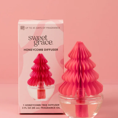Pink honeycomb diffuser with packaging on a pink background
