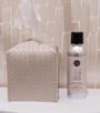 Bottle of Sweet Grace product on a white surface with a textured beige wall background