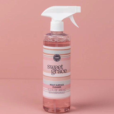 Bottle of Sweet Grace multi-purpose cleaner on a pink background