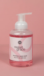 Bottle of sweet grace foaming hand soap on a pink background