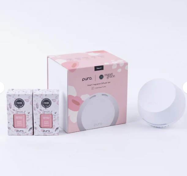 Pura smart fragrance diffuser set with packaging on a white background