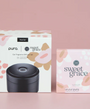 Pura car fragrance diffuser set with packaging on a pink background
