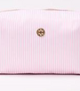 Pink ribbed clutch bag with a gold clasp on a white background