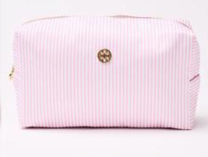 Pink ribbed clutch bag with a gold clasp on a white background