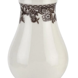 White ceramic jar with decorative lace band on a white background