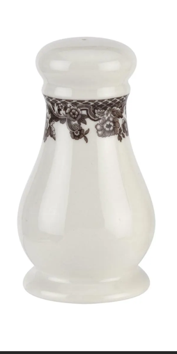 White ceramic jar with decorative lace band on a white background