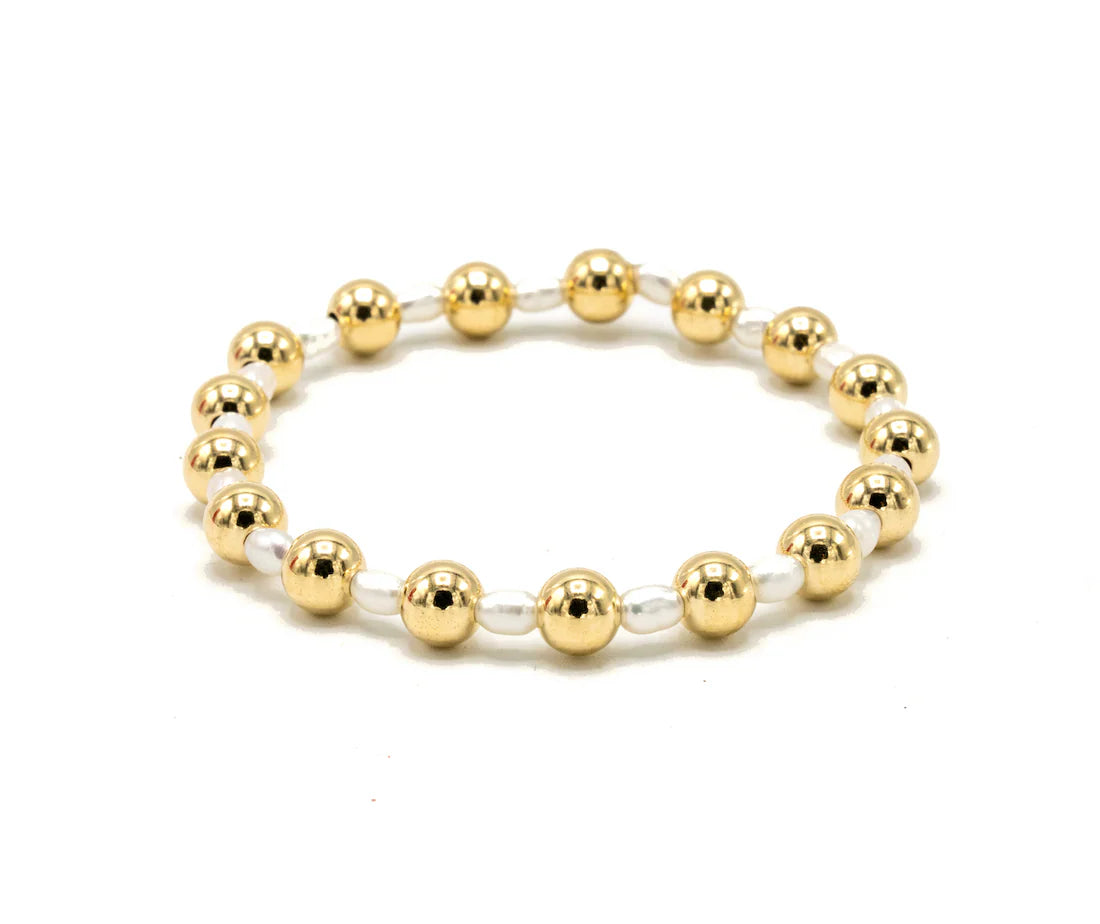 Gold beaded bracelet on a white background