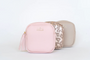 Two pink and beige cosmetic bags with 'Hollie' branding on a light gray background