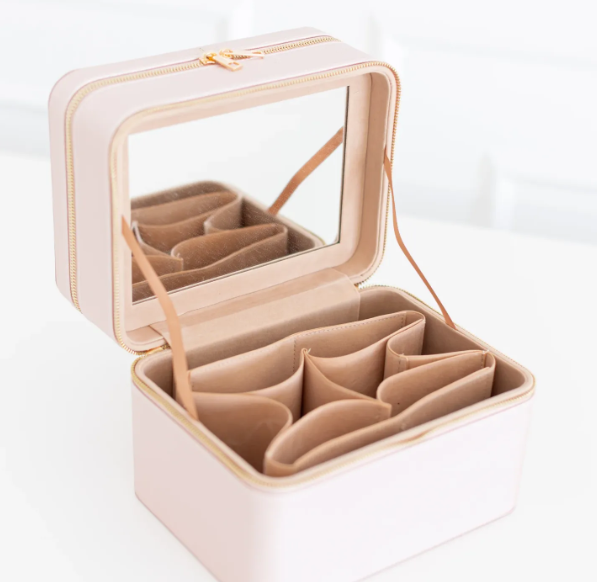 Beige jewelry case with compartments on a white background