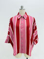 A pink and red striped button-down shirt with white stripes, displayed on a mannequin torso against a white background.