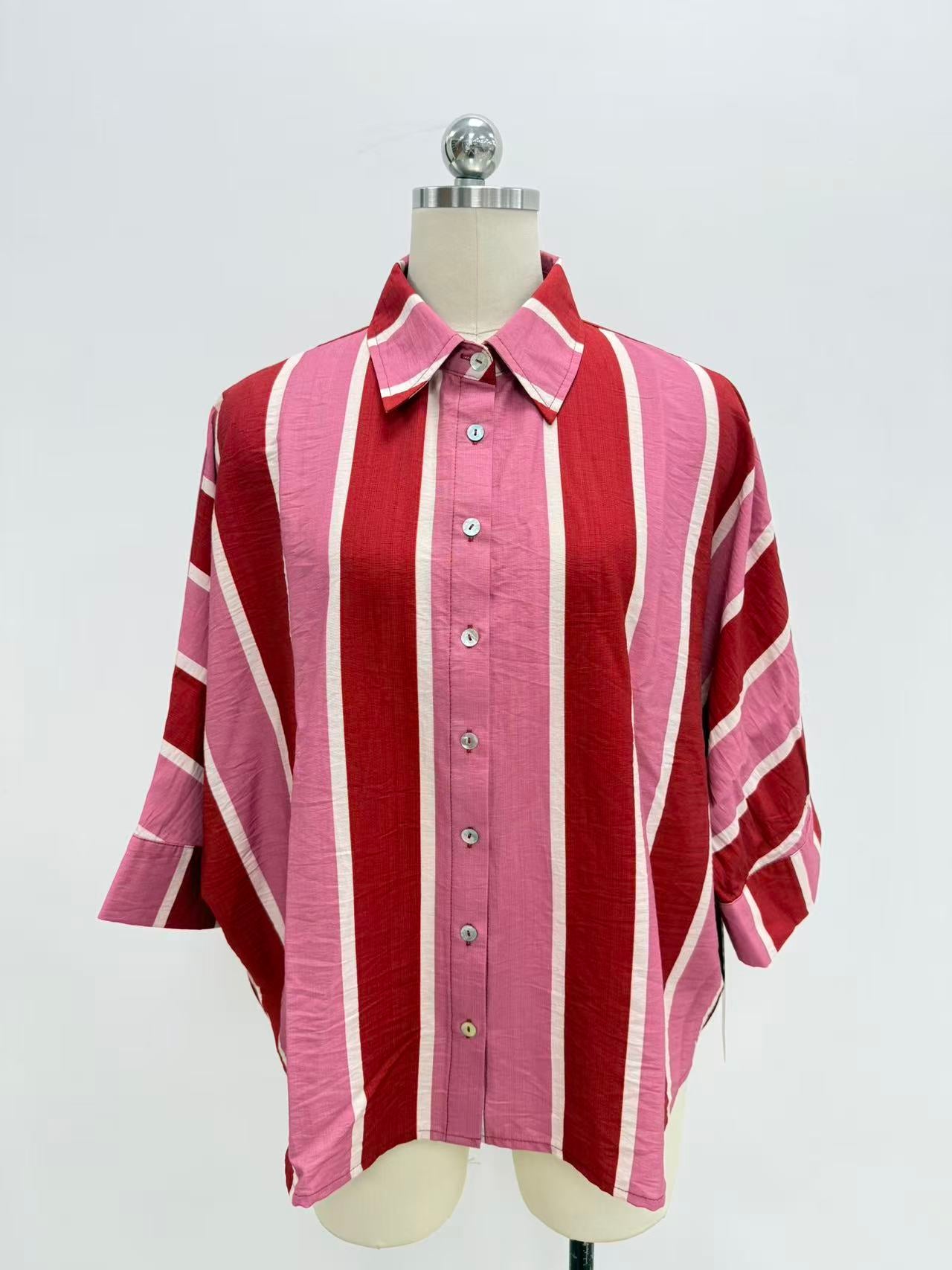 A pink and red striped button-down shirt with white stripes, displayed on a mannequin torso against a white background.