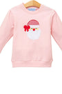 A light pink long-sleeve crewneck sweatshirt for kids, featuring an embroidered Santa Claus face on the front with a red and white checkered hat and red bow.