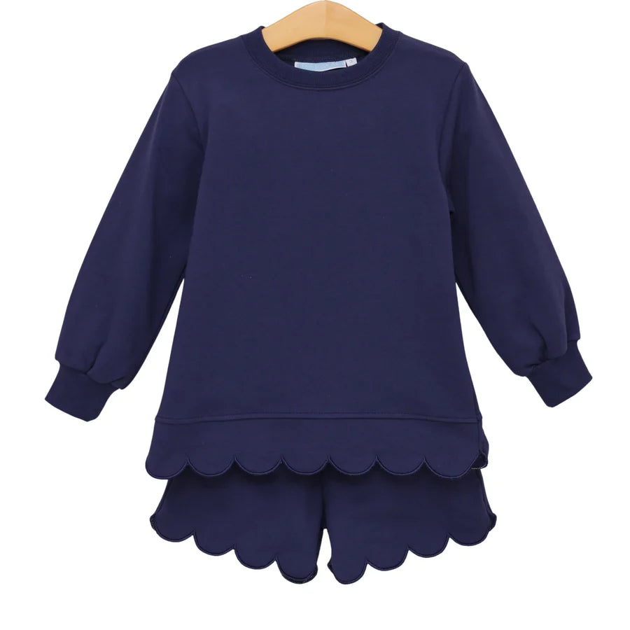 Navy blue dress with scalloped hem on a white background