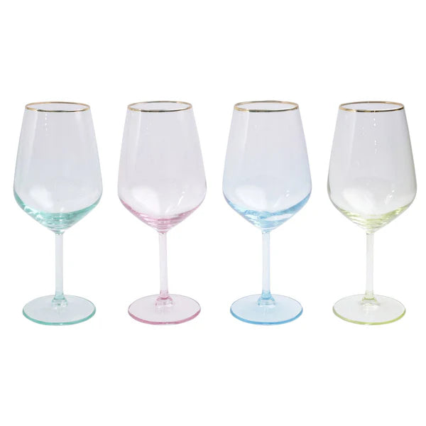 Four wine glasses with pastel-colored bases on a white background