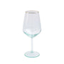 Clear wine glass with gold rim on a white background