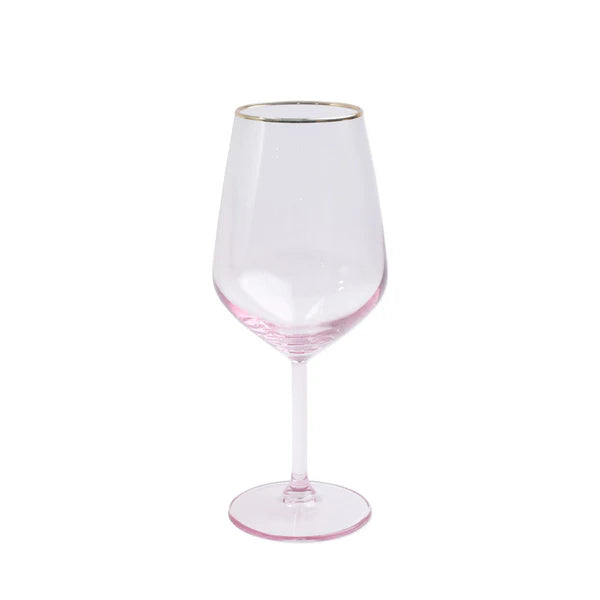 Clear wine glass with pink base and gold rim on a white background