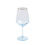 Clear wine glass with gold rim on a white background