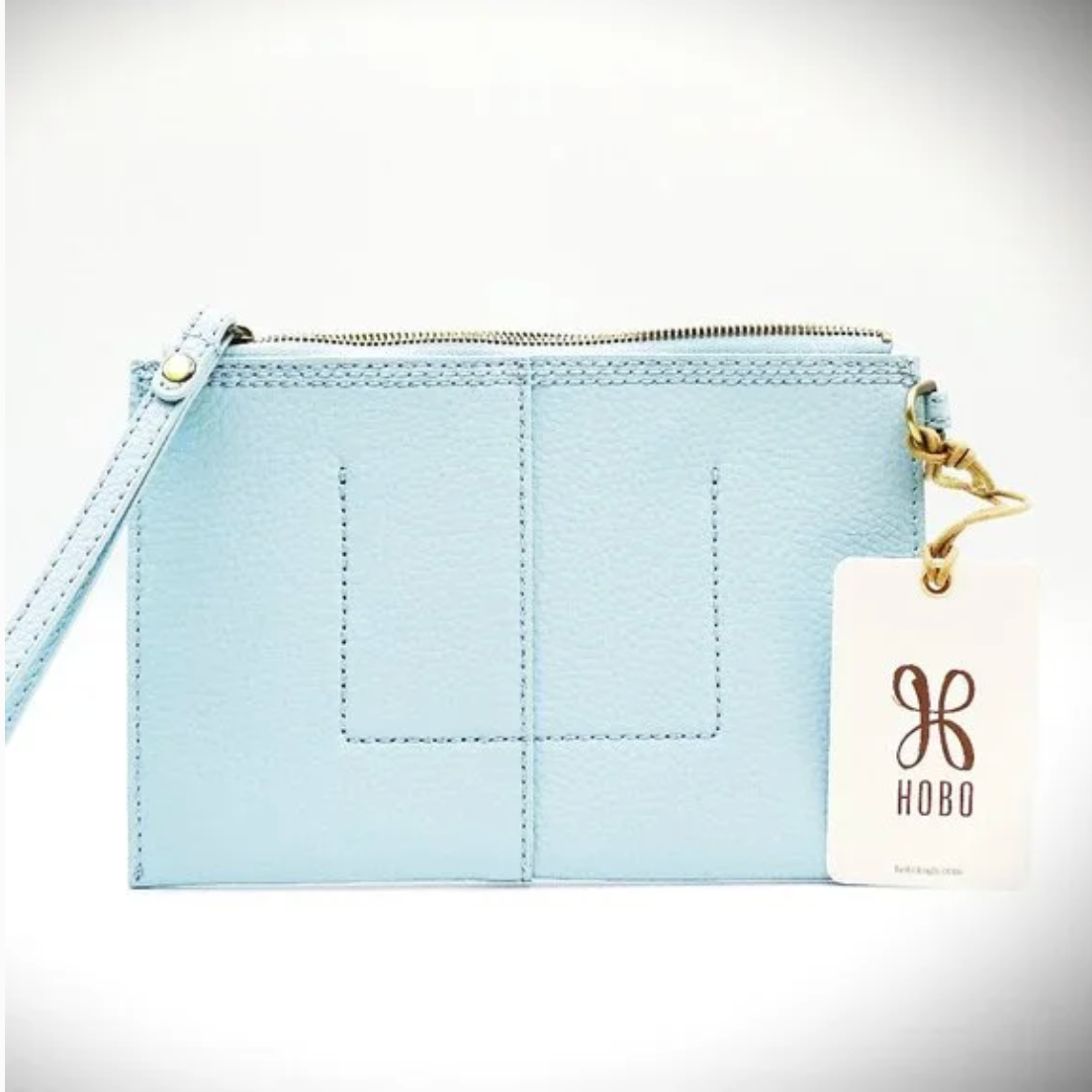 Light blue pouch with a gold zipper and 'Hobo' brand tag on a white background