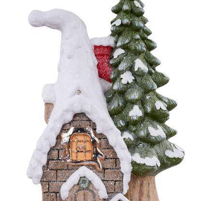 Small snowy cabin with a tree next to it on a white background